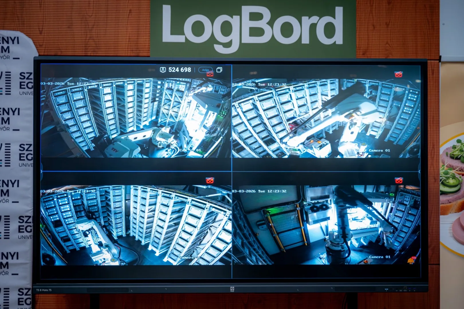 监控画面显示，自动化商店内的机械臂正在“作业”。（摄影：András Adorján）